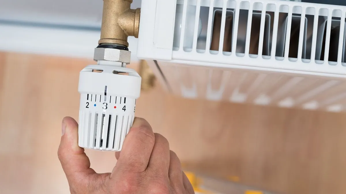 Close-up,Of,A,Person's,Hand,Adjusting,Temperature,Of,Radiator,Thermostat