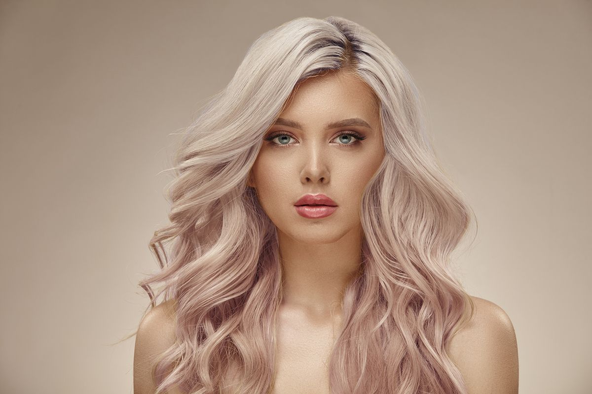Gorgeous,Woman,With,Beautiful,Wavy,Pink,Hair,On,A,Beige