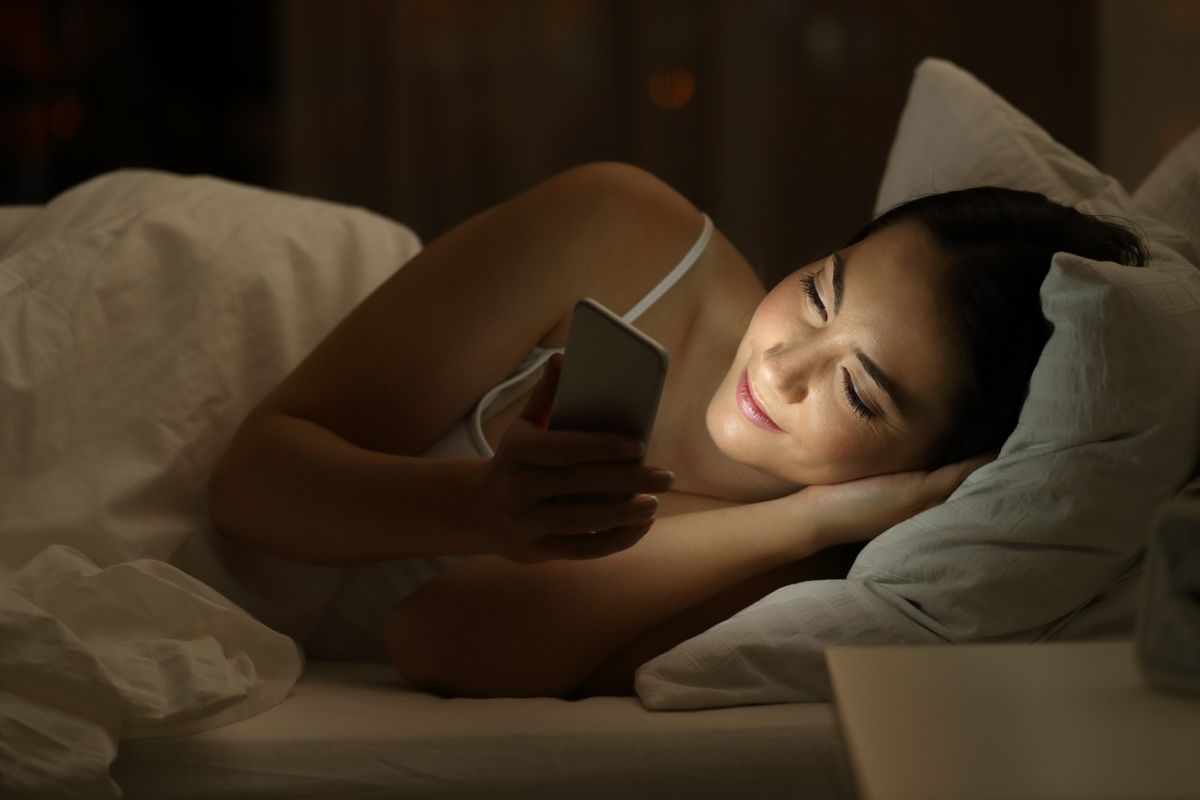 Relaxed,Girl,Using,A,Smart,Phone,Lying,On,The,Bed