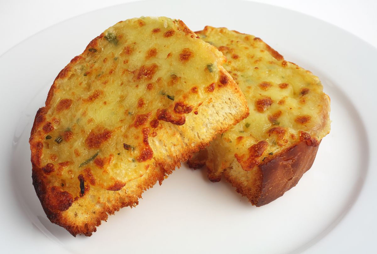 Two,Pieces,Of,Garlic,Bread,Topped,With,Cheese,On,A