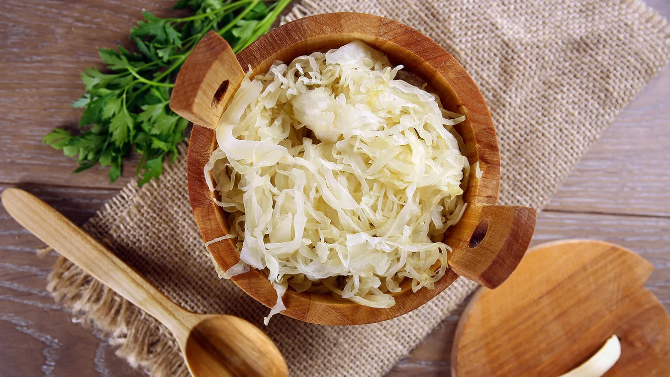 Sauerkraut,In,A,Wooden,Barrel,On,Brown,Table