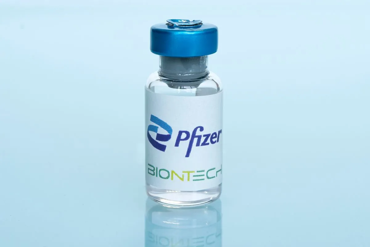 Glass,Bottle,And,Logos,Pfizer,And,Biontech,On,A,Blue