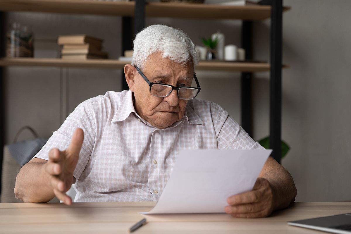 Confused,Frustrated,Elder,Senior,80s,Man,In,Glasses,Reading,Document