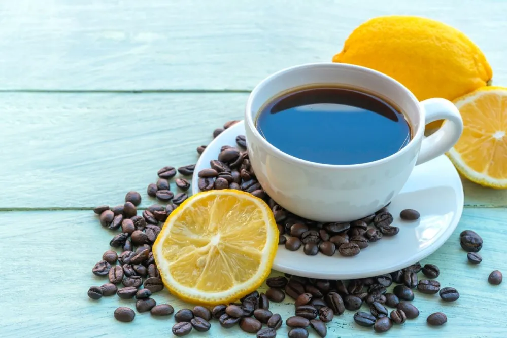 Lemon,Black,Coffee,In,White,Cup,,Coffee,Beans,,Lemon,Slices