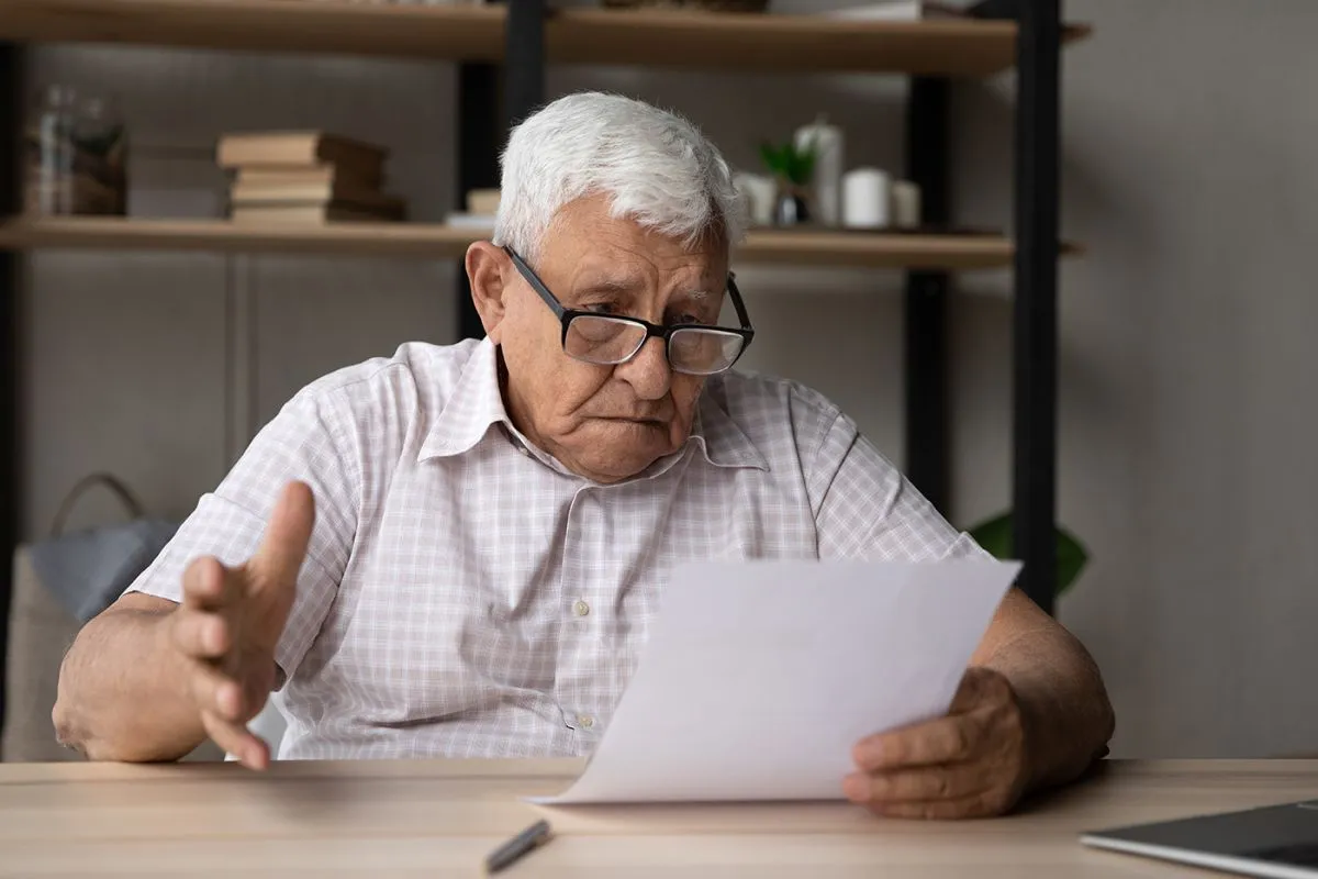 Confused,Frustrated,Elder,Senior,80s,Man,In,Glasses,Reading,Document