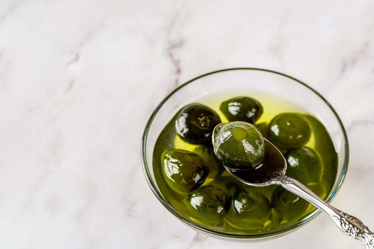 Close-up,Of,Delicious,Conserved,Unripe,Fig,On,A,Spoon,Over