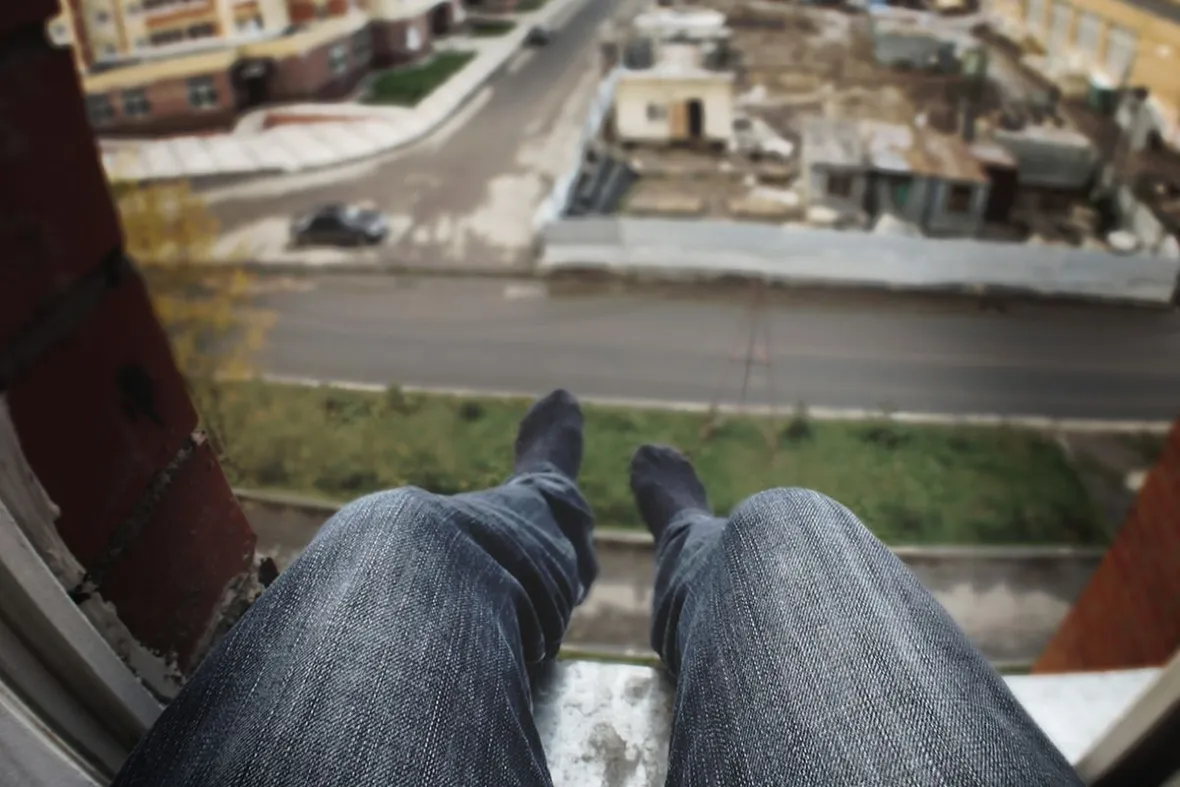 A,Man,With,Depression,Sits,On,The,Window,,Wants,To