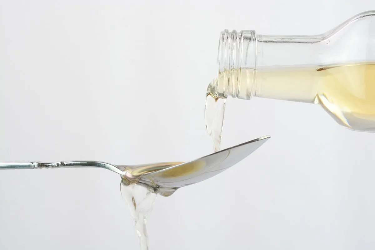 Pouring,Apple,Cider,Vinegar,In,A,Spoon