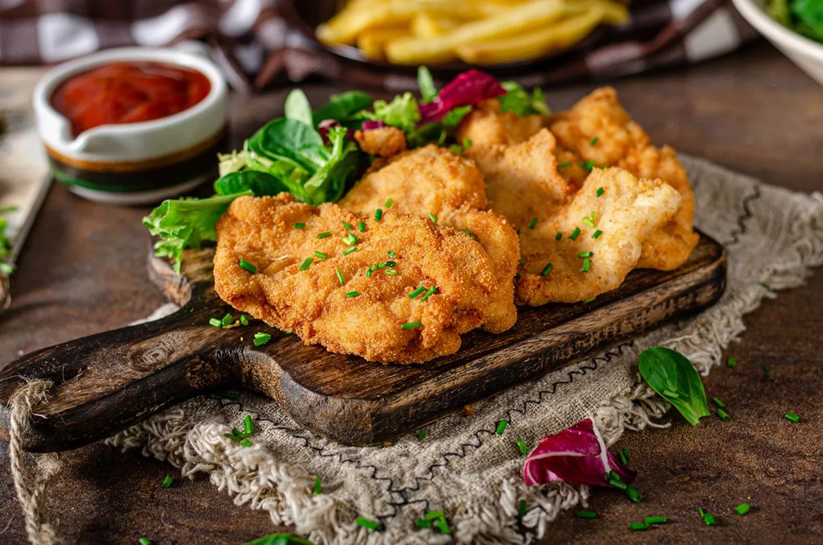 Tender,Schnitzel,With,Fresh,Salad,,Tomatoes,And,French,Fries