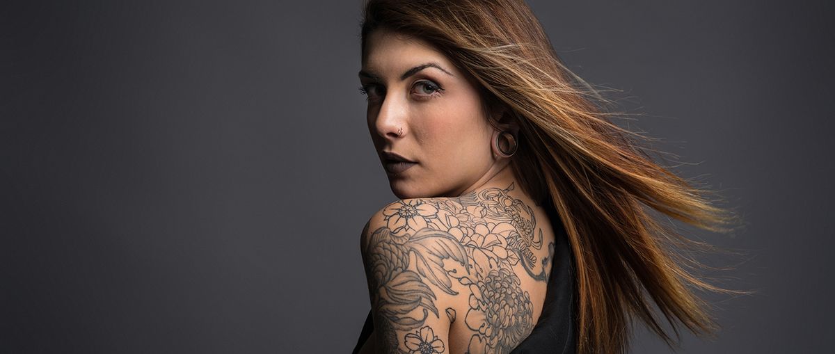 Beautiful,Woman,Studio,Portrait,With,Tattoos,On,Her,Shoulder.