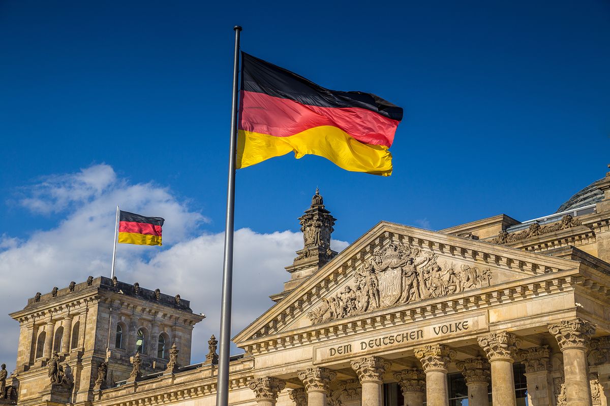 German,Flags,Waving,In,The,Wind,At,Famous,Reichstag,Building,