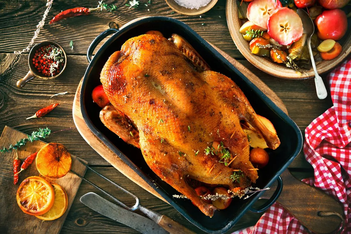 Roast,Christmas,Duck,With,Thyme,And,Apples,On,Rustic,Wooden