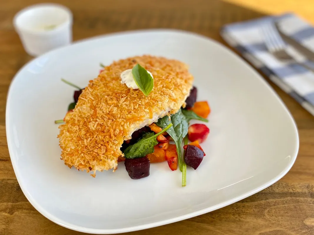 Crumbed,Chicken,On,A,Bed,Of,Roasted,Vegetable