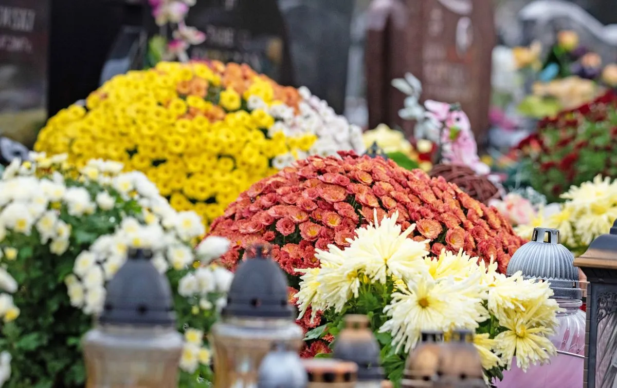 All,Saints',Day,And,Burning,Candles,Next,To,Flowers,On