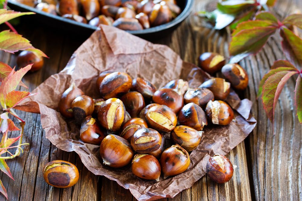 Roasted,Chestnuts,On,An,Old,Board.,Selective,Focus.