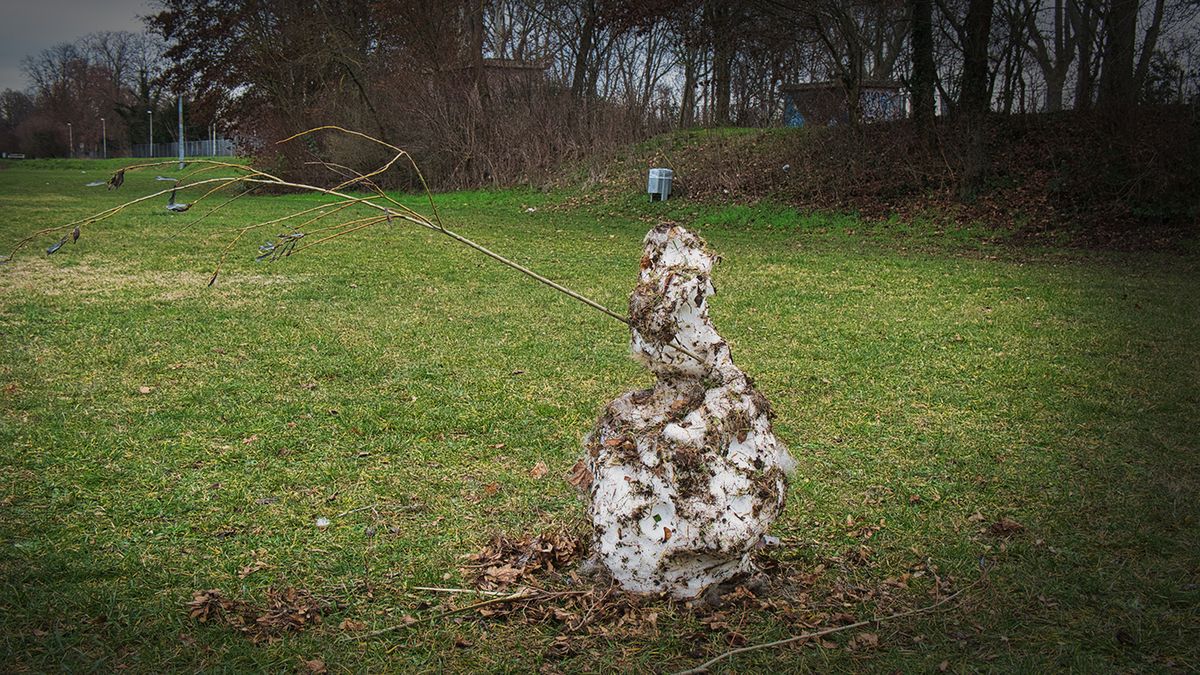 A,Melting,,Dirty,Snowman,With,A,Branch,Is,Symptomatic,Of
