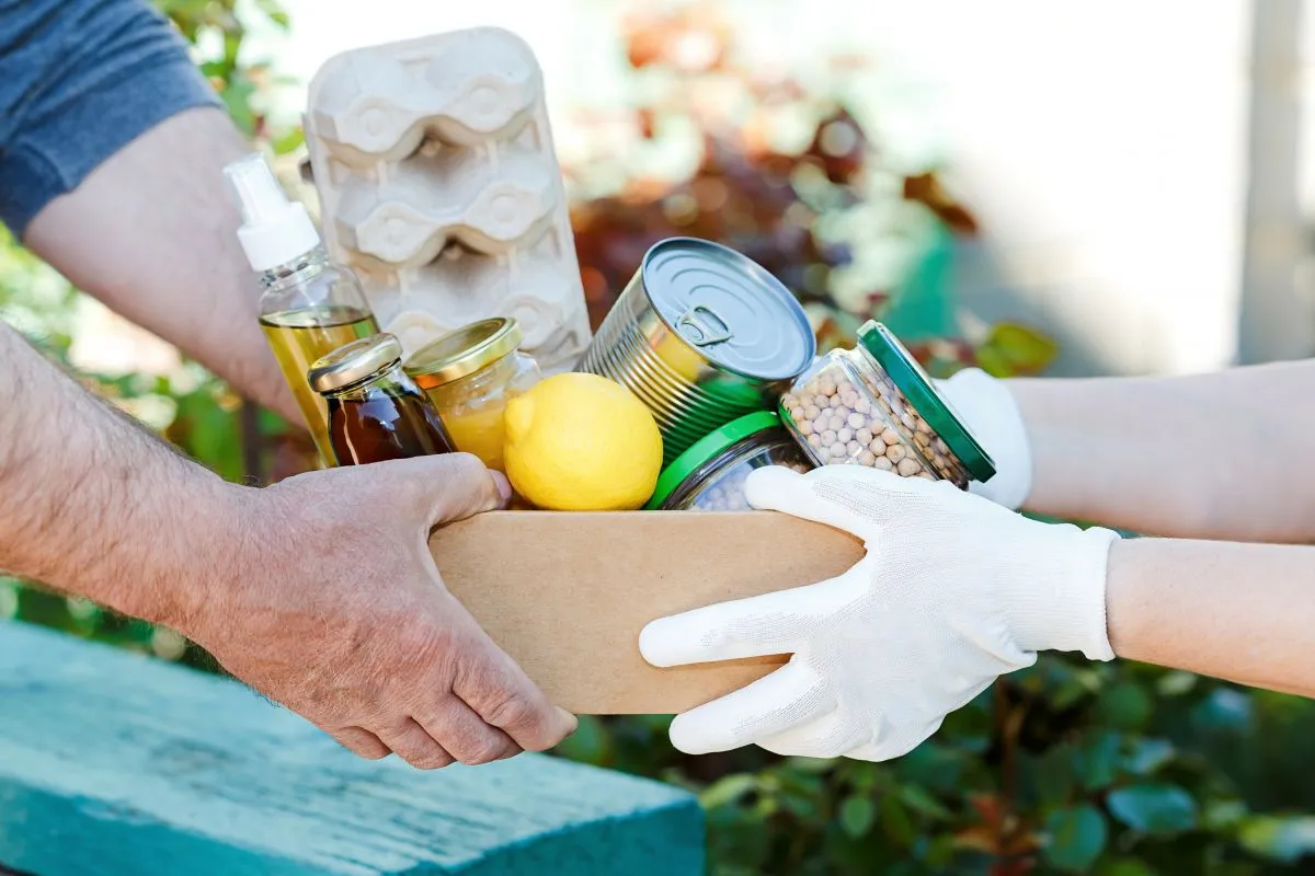 Donation,Box,With,Various,Food.,A,Volunteer,Passes,A,Cardboard