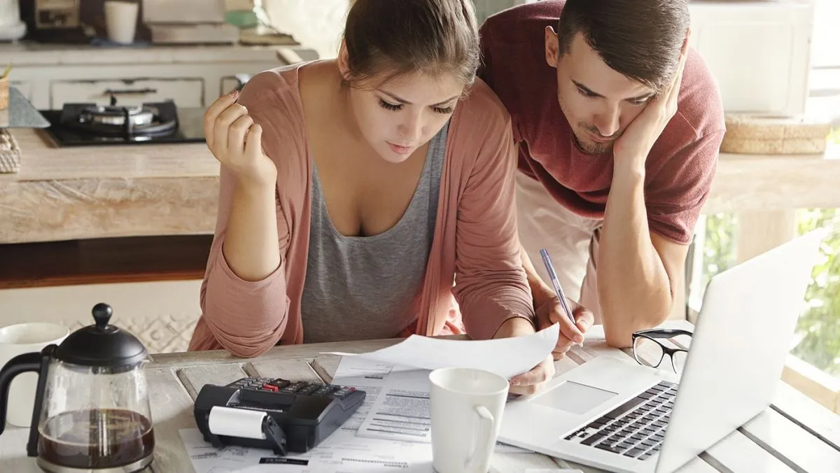 Young,Married,Couple,With,Many,Debts,Doing,Paperwork,Together,,Reviewing