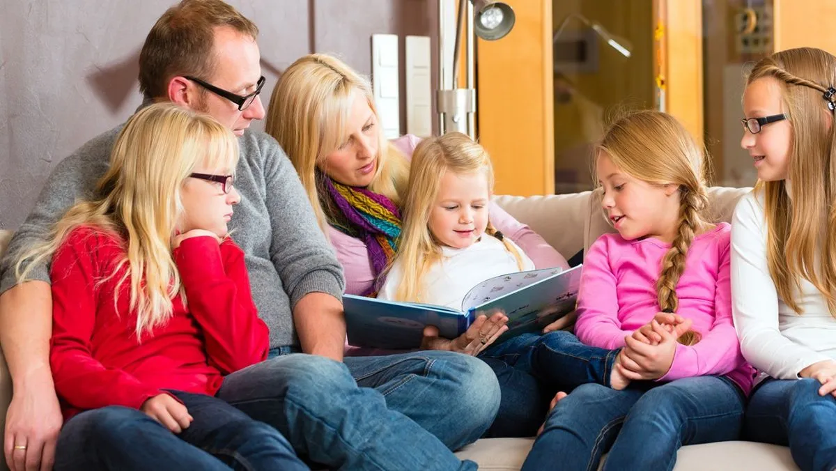 Family,Sitting,Together,With,Mother,,Father,And,Children,Comfortable,On