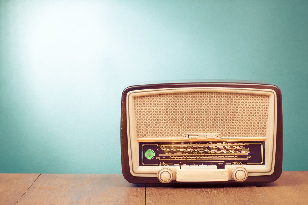 Old,Retro,Radio,With,Green,Eye,Light,On,Table,Front