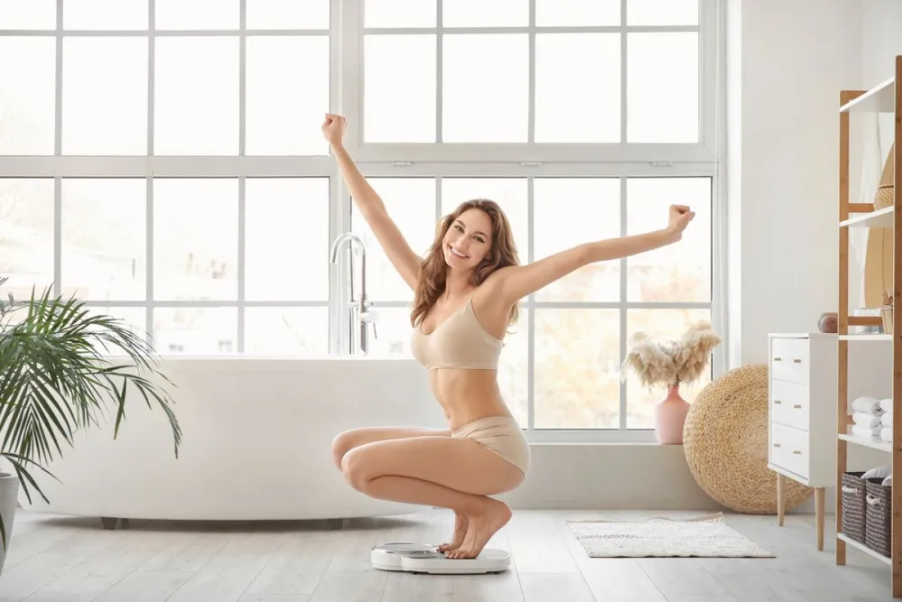 Young,Woman,Measuring,Her,Weight,At,Home