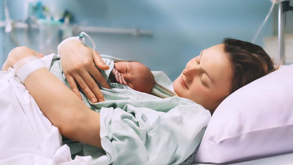 Mother,And,Newborn.,Child,Birth,In,Maternity,Hospital.,Young,Mom
