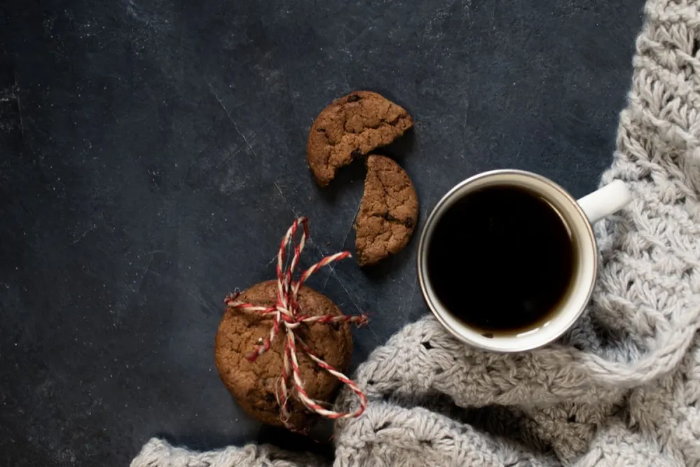 Winter,Composition.,Cup,Of,Coffee,,Cookie,,Lights,,On,A,Dark