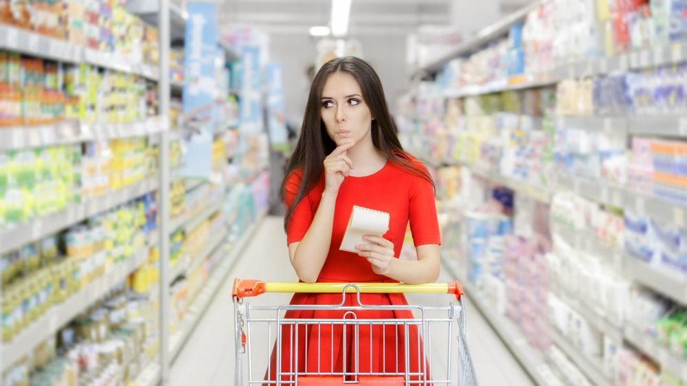 Curious,Woman,In,The,Supermarket,With,Shopping,List-,Young,Girl