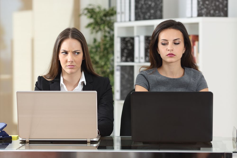 Front,View,Of,Two,Angry,Businesswomen,Looking,Each,Other,With