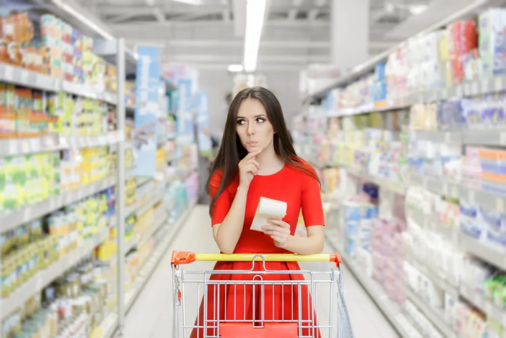 Curious,Woman,In,The,Supermarket,With,Shopping,List-,Young,Girl
