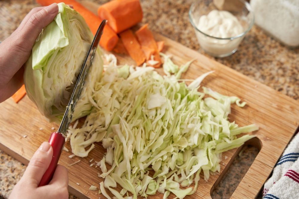 Unrecognizable,Woman,Hands,Chopping,Cabbage,,Prepares,Home,Made,Coleslaw