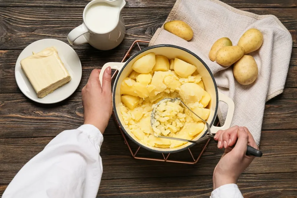 Woman,Preparing,Tasty,Mashed,Potatoes,On,Wooden,Background,,Closeup
