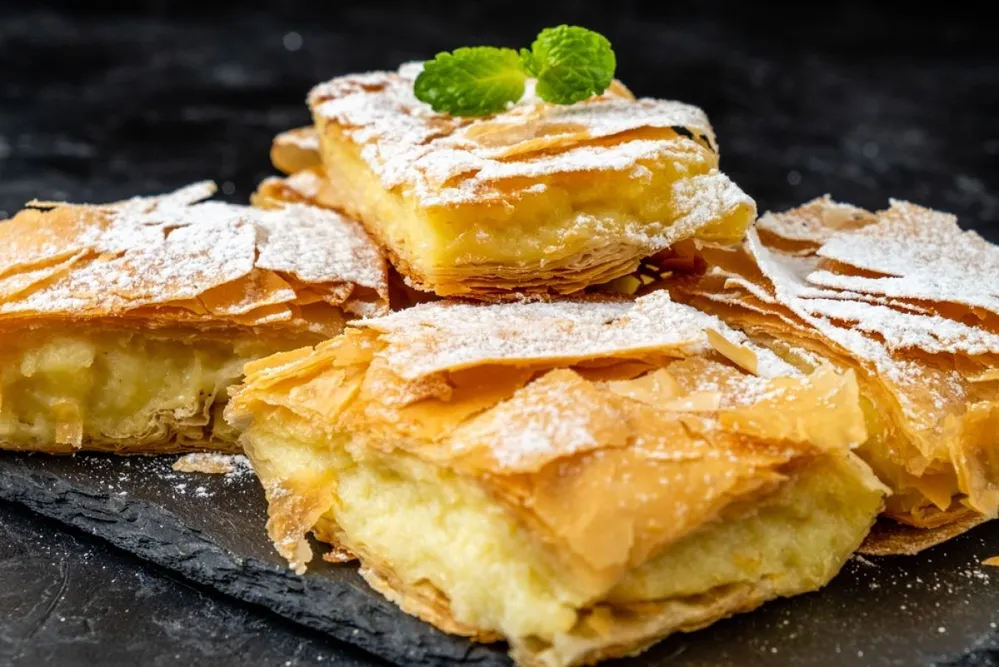 Greek,Bougatsa,Sliced,On,A,Dark,Table.,Close-up.