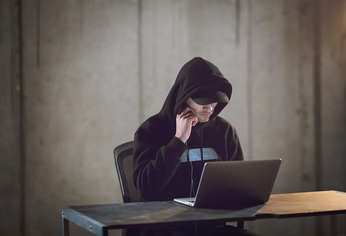 Young,Talented,Hacker,Using,Laptop,Computer,While,Working,In,Dark
