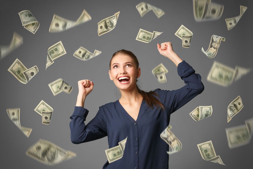 Young,Woman,With,Money,On,Grey,Background