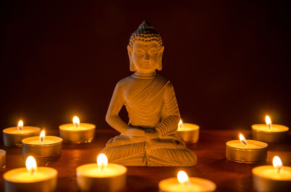 Little,Buddha,Statue,Surrounded,By,Tea,Candles