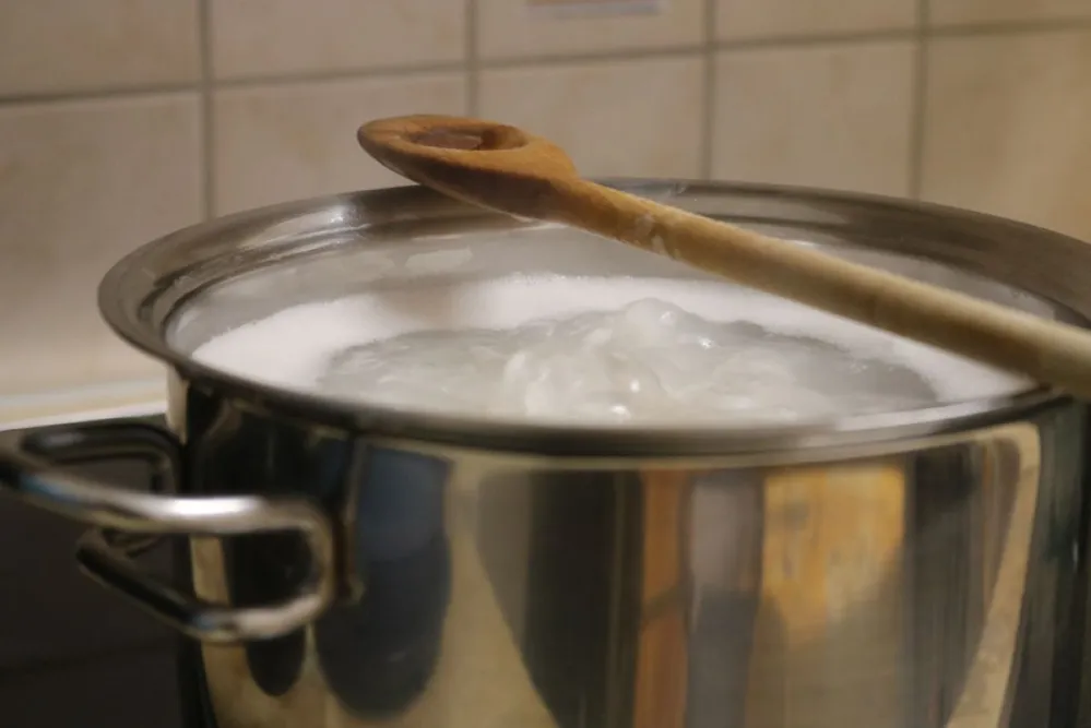 Boiling,Water,In,A,Pan,,Wood,Spoon,On,The,Top