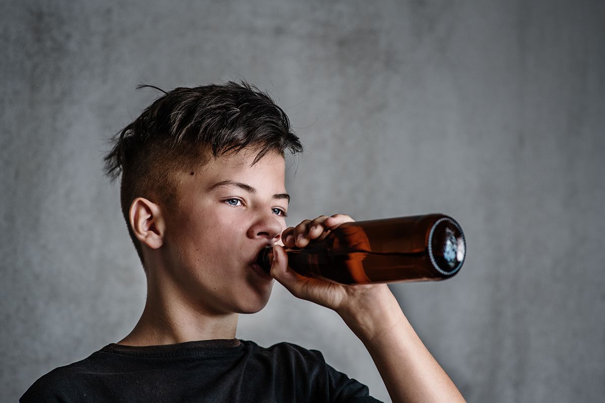 Boy,Teenager,Drinking,Alcohol,From,A,Bottle