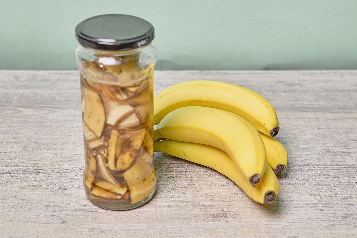 A,Jar,Filled,With,Banana,Peel,Cuts,And,Water.,Banana
