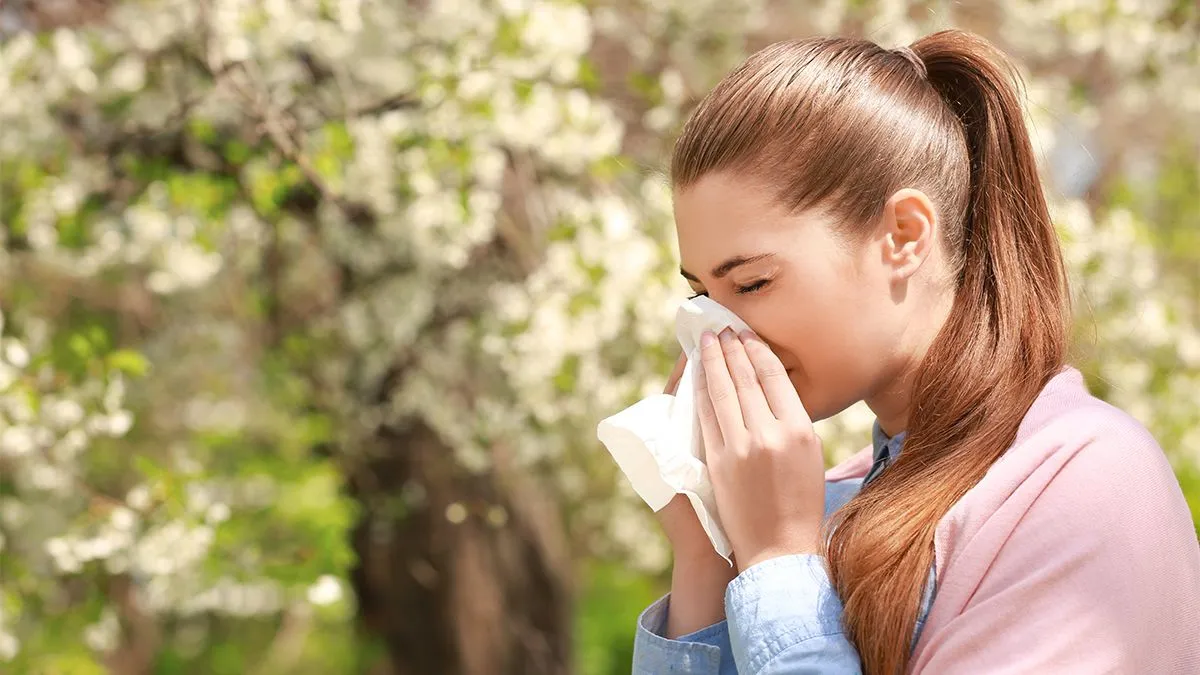 Sneezing,Young,Girl,With,Nose,Wiper,Among,Blooming,Trees,In