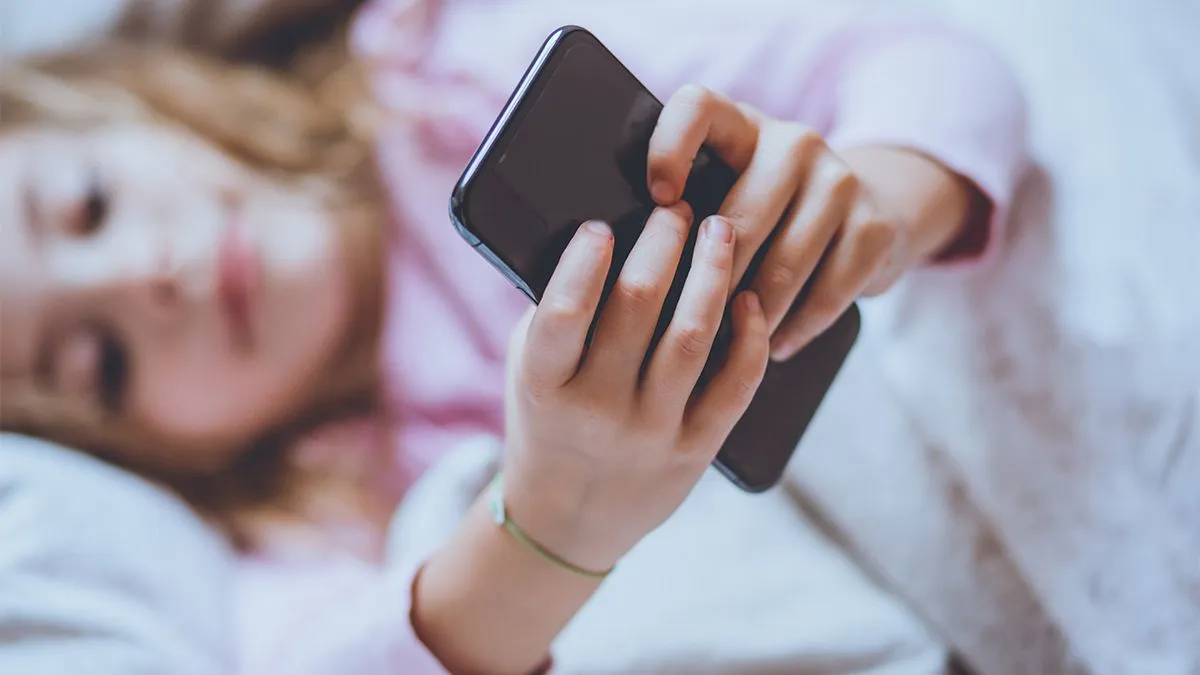 Curious,About,Modern,Technology.,Little,Girl,Lying,On,Bed,And