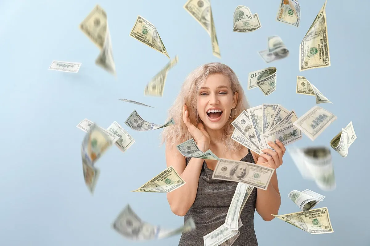 Beautiful,Young,Woman,With,Flying,Money,On,Grey,Background