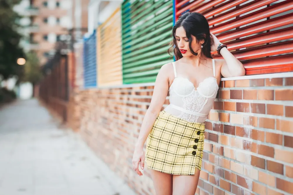 Woman,Lean,Against,A,Wall,In,A,Skort,And,Bodysuite