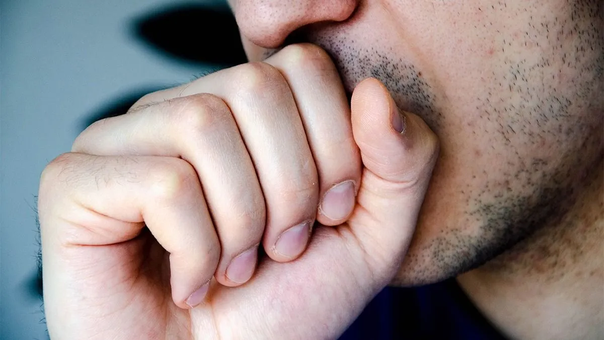 A,Man,In,Close-up,Coughs,In,His,Hand,,Fist.,Cough.