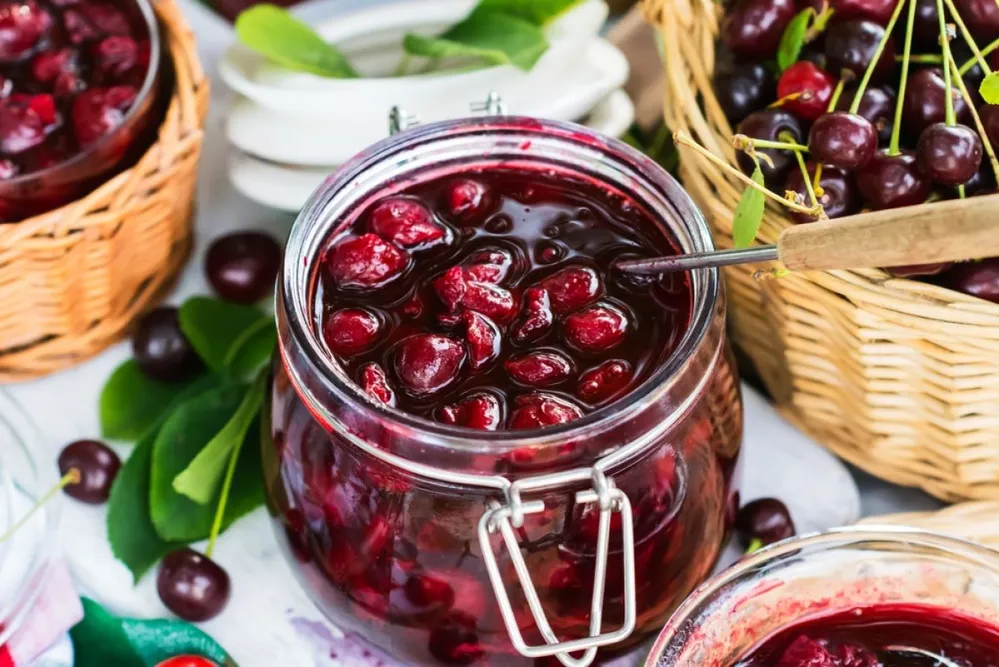 Cooked,Homemade,Cherry,Jam,In,Glass,Jar,On,White,Wooden