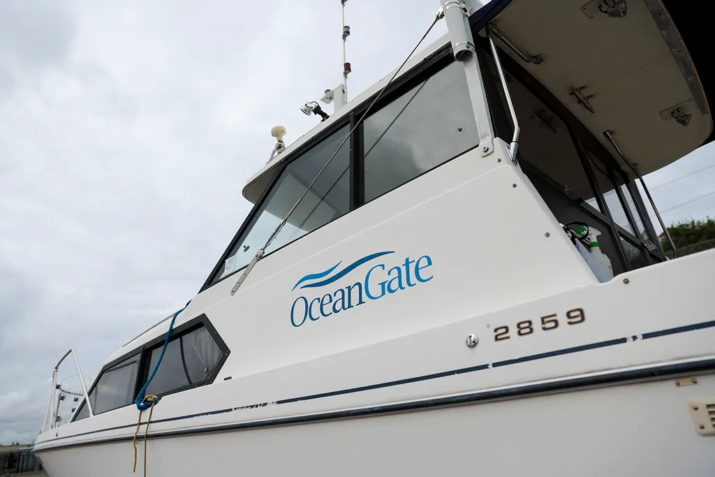 The OceanGate logo is pictured on a boat at the Port of Everett Boat Yard in Everett, Washington, on June 20, 2023. Deep-sea thrill-seeker Stockton Rush founded OceanGate in 2009 with the hopes of advancing submersible vehicle technology and taking travelers into the darkest depths of the ocean. During such a mission on June 18, 2023, the submersible -- with Rush onboard -- went missing, losing contact with the surface ship less than two hours after it began its descent. An international search effort was launched to try and find Rush and the four other passengers in the remote North Atlantic, but no sign of them has been found. (Photo by Jason Redmond / AFP)