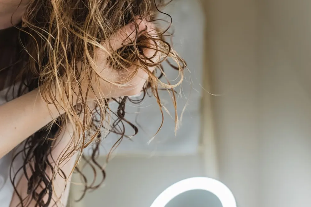 Woman,Scrunching,Her,Hair,To,Form,Curls.,Applying,Curly,Method