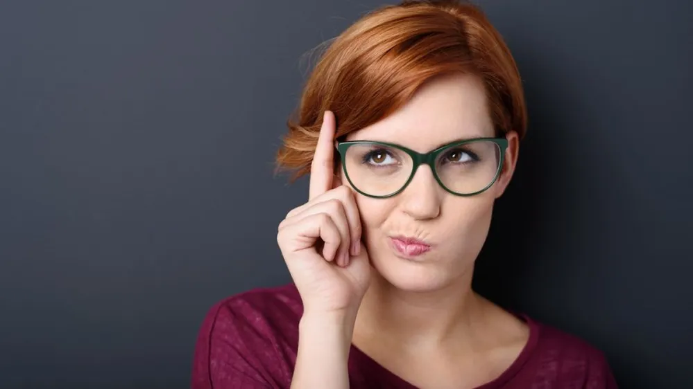 Nerdy,Scholastic,Young,Woman,Wearing,Geeky,Glasses,Standing,Thinking,With