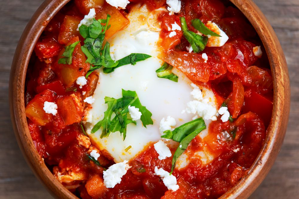 Fresh,Eggs,Poached,In,Tomato,Sauce,And,Red,,Yellow,Pepper,