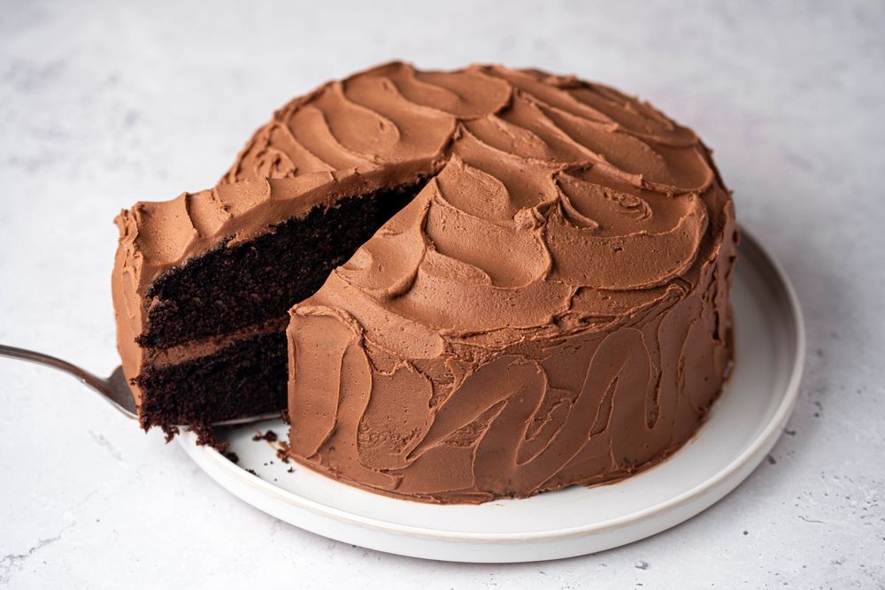 Chocolate,Cake,With,A,Cut,Piece,On,Plate,.